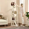 A woman is interacting with cats on a cat tree in a living room. Produktbild-Vorschau