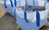 Two large white bulk bags filled with stones, placed on a sandy surface. Produktbild-Vorschau