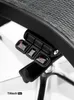 Close-up of chair controls on a black mesh office chair. Anteprima dell’immagine prodotto
