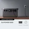 A portable power station is plugged into a wall outlet, charging. Náhled obrázku produktu