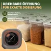 A close-up of several transparent food storage containers filled with various dry goods, with a focus on a single container in the foreground showing its dispensing mechanism. The background is a wooden surface. Produktbild-Vorschau