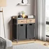 A laundry cart with two drawers and two fabric bins is placed in a room next to a window with curtains. Voir les images du produit