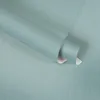 A roll of teal textured wallpaper is shown, with a portion unrolled. Produktbild-Vorschau