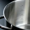 A close-up view of the inside of a stainless steel pot with volume markings. Náhled obrázku produktu