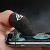 A finger wearing a gaming glove is touching a smartphone screen displaying a game. Produktbild-Vorschau