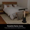 A couple sleeping in a bed with a fan in the foreground. Podgląd zdjęcia produktu