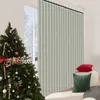 A Christmas tree decorated with ornaments and a "Merry Christmas" sign is placed next to a light gray vertical blind in a room with two decorative pillows. Anteprima dell’immagine prodotto