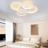 A modern bedroom with a bed, nightstands, and a large window. Voir les images du produit