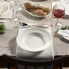 A table setting with plates, cutlery, glasses, and bread. Náhľad obrázku produktu