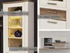 A collage of images showcasing a white and wood-tone cabinet with drawers and shelves, highlighting features like LED lighting and handles. Produktbild-Vorschau