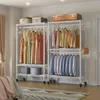 A bedroom with two rolling garment racks filled with clothes, a suitcase on top, and boxes on the bottom shelf. Voir les images du produit