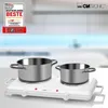 A dual electric hot plate with two pots on top, set against a blurred kitchen background. A promotional badge is in the top left corner. Náhled obrázku produktu