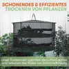 A black mesh drying net with multiple shelves, filled with green plant material, is suspended outdoors in front of a white background and surrounded by green foliage. Náhľad obrázku produktu