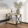 A side table with books and a vase of flowers next to a sofa. Podgląd zdjęcia produktu