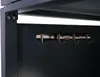A close-up view of a metal rack with four hooks mounted on a dark gray panel. Náhled obrázku produktu