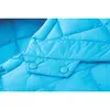 A close-up view of a quilted blue fabric with two buttons. Produktbild-Vorschau