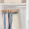 Pants and skirts hanging on hangers in a closet. Produktbild-Vorschau