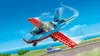 A Lego stunt plane flying over a runway with a pilot inside. Podgląd zdjęcia produktu