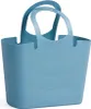 A blue tote bag with curved lines on its side and two handles. Voir les images du produit