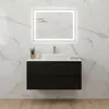 A modern black vanity cabinet with a white sink and a gold faucet is mounted on a marble-tiled wall. Produktbild-Vorschau