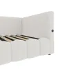 Close-up view of a white upholstered bed frame, showing the headboard and side panel. Voir les images du produit