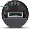 The underside of a black round robot vacuum cleaner with green brushes and wheels, and a gray cleaning pad at the bottom. Podgląd zdjęcia produktu