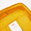 Close-up view of the inside of a yellow backpack, showing a label with brand information and a Swedish flag. Anteprima dell’immagine prodotto