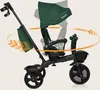 A dark green Lionelo Kori tricycle with a black frame, shown from the side against a light beige background. Arrows indicate rotation and movement of the seat and handle. Produktbild-Vorschau