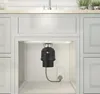 A garbage disposal unit installed under a kitchen sink. Produktbild-Vorschau