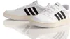 A pair of white Adidas sneakers with black stripes on a white reflective surface. Anteprima dell’immagine prodotto
