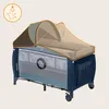A baby crib with a mosquito net canopy. Produktbild-Vorschau