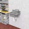 A utility sink mounted on a concrete wall in a workshop or garage setting, with storage bins and tools nearby. Produktbild-Vorschau