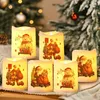 A group of six flameless LED Christmas candles with festive designs of Santa Claus and snowmen are arranged on a surface, with a blurred Christmas tree in the background. Produktbild-Vorschau