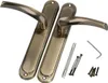 A pair of antique bronze door handles with accompanying screws and an Allen key, laid out on a white background. Produktbild-Vorschau