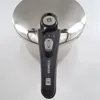 A close-up view of the top of a pressure cooker, focusing on the handle and lid mechanism. Podgląd zdjęcia produktu