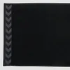 A close-up view of a black towel with a grey chevron pattern on the left edge. Produktbild-Vorschau