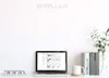A desk setup with a laptop, books, a mug, and a plant. Produktbild-Vorschau