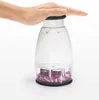 A hand presses down on the top of a manual food chopper filled with chopped red onions. Produktbild-Vorschau