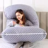 A woman is holding a baby while lying on a large, star-patterned pregnancy pillow. Náhled obrázku produktu