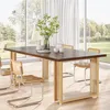 A dining table set in a bright, modern room with large windows overlooking a garden. Anteprima dell’immagine prodotto