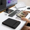 A desk setup with a laptop, monitor, keyboard, tablet, and a laptop sleeve. Produktbild-Vorschau