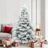 A flocked Christmas tree with gifts underneath, in a living room setting. Náhled obrázku produktu