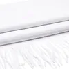A close-up, folded white scarf with fringes. Anteprima dell’immagine prodotto