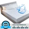 A white quilted mattress protector on a bed, with water splashing on it. Náhled obrázku produktu
