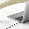 A close-up shot of a laptop with a black AUX cable plugged into its side, resting on a white surface. Anteprima dell’immagine prodotto
