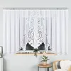A white lace curtain hanging on a window. Anteprima dell’immagine prodotto