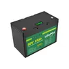 A black lithium-ion battery with a green label and a small digital display on top. Náhled obrázku produktu