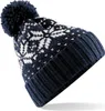 A close-up, angled view of a knitted beanie with a snowflake pattern.