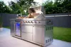 An outdoor kitchen setup with a grill, sink, and refrigerator in a backyard setting. Podgląd zdjęcia produktu