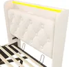 A close-up view of a white upholstered bed frame with a tufted headboard and integrated LED lighting. Náhled obrázku produktu